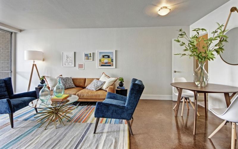 a living room with a couch and chairs