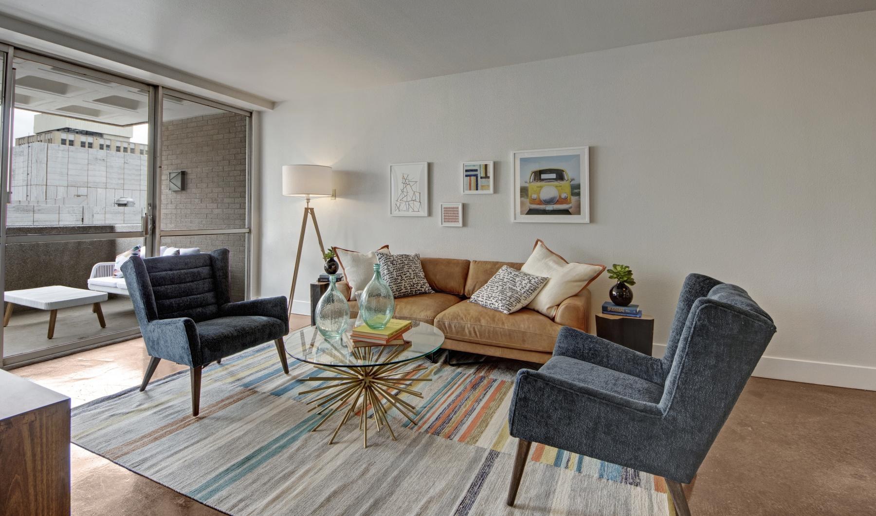 a living room with a couch and chairs