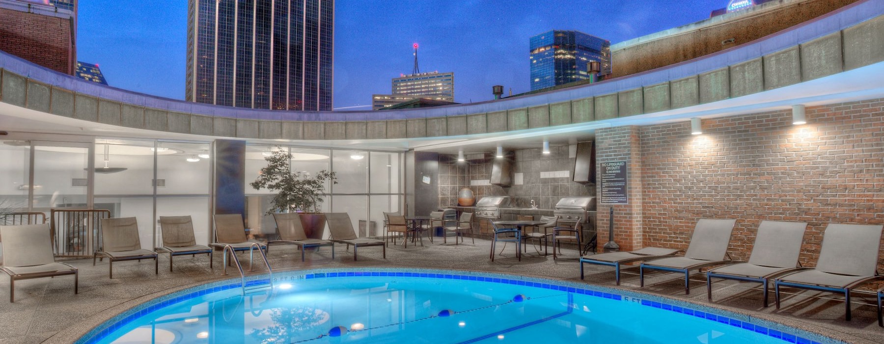 a pool with chairs and tables by it