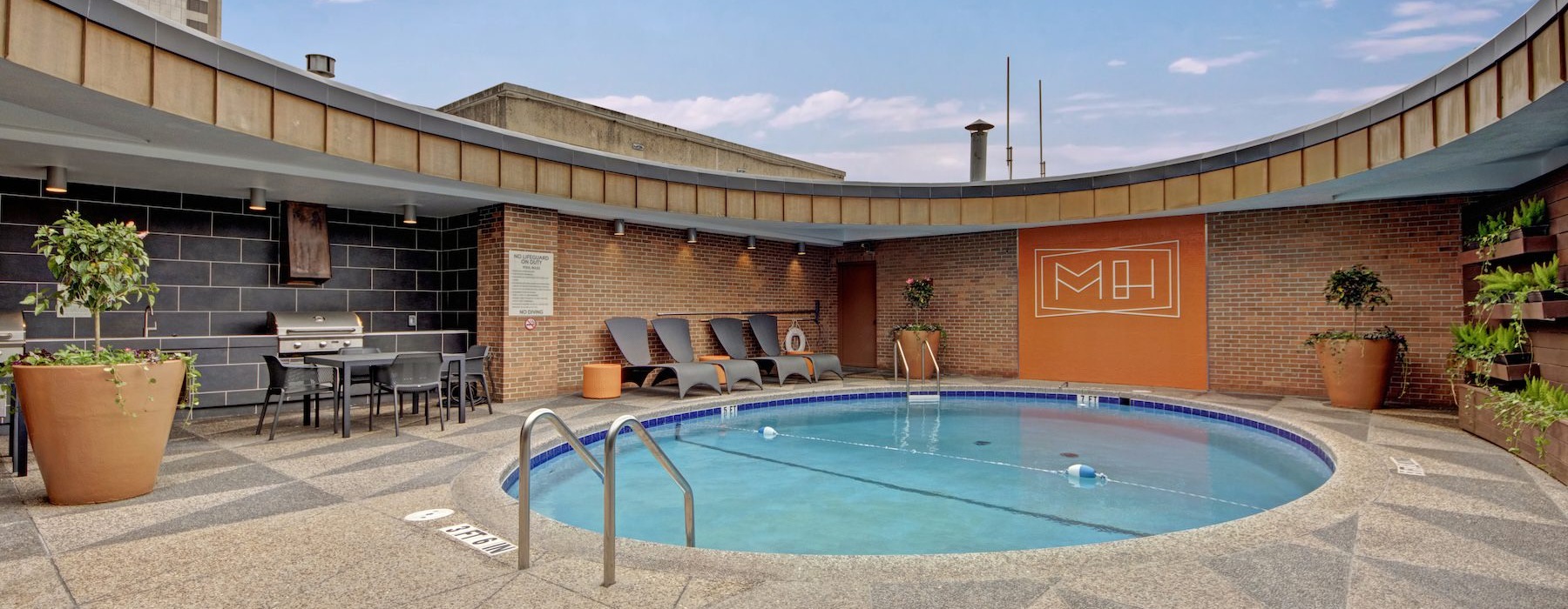 a swimming pool with lounge chairs