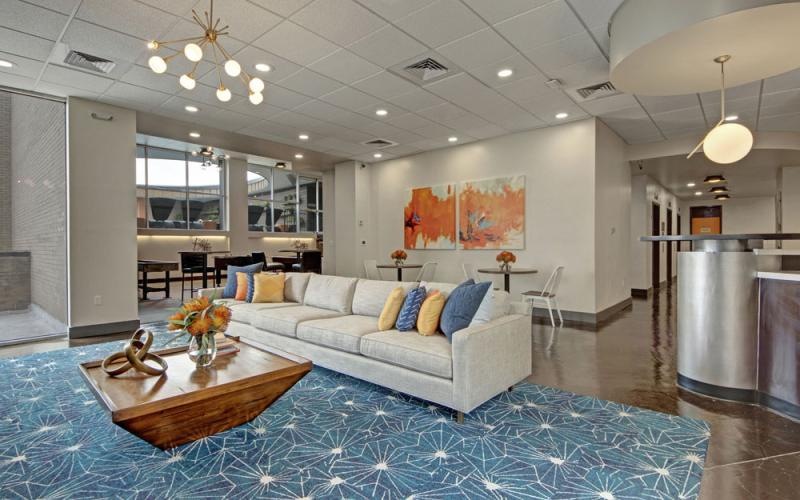 a lounge with a couch and a coffee table